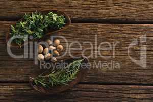 Nutmeg and rosemary herbs  on a wooden table