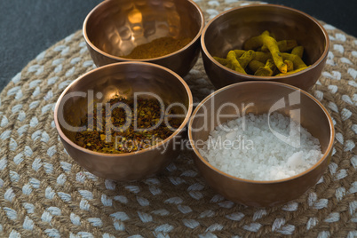 Various spices in bowl on a place mat