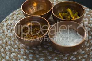 Various spices in bowl on a place mat