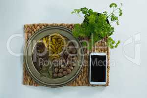 Various spices on plate with mobile phone