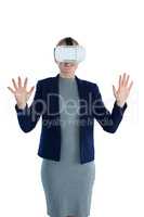 Smiling businesswoman gesturing while wearing vr glasses
