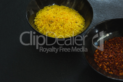 Crushed red pepper and yellow rice in bowl