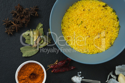 Rice in bowl with various spices and ingredients