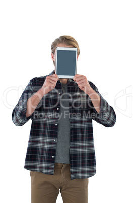 Businessman holding digital tablet in front of face