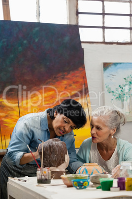 Woman painting a sculptor