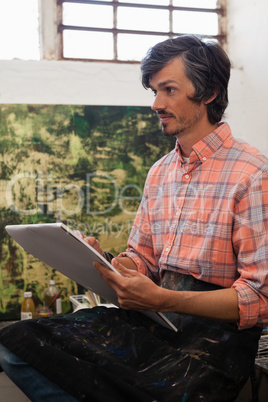 Man drawing a portrait in drawing book