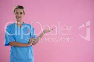 Portrait of happy female doctor in scrubs gesturing