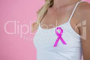 Mid section of woman with Breast Cancer Awareness ribbon
