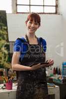 Portrait of beautiful woman holding digital tablet