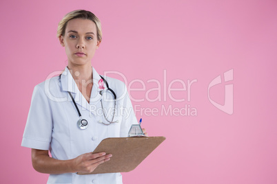 Portrait of female doctor with clipboard