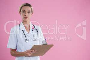 Portrait of female doctor with clipboard