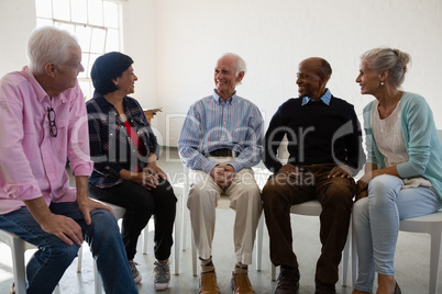 Friends talking during discussion in art class