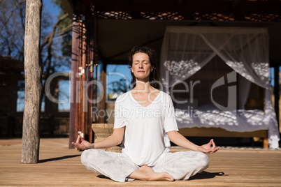 Woman practicing yoga on wooden plank