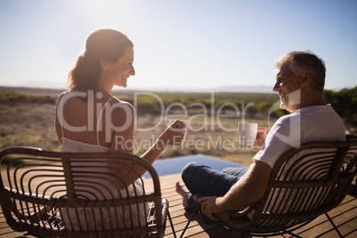 Senior couple having coffee while sitting