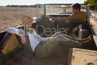 Woman resting with man driving off road vehicle Woman resting with man driving off road vehicle