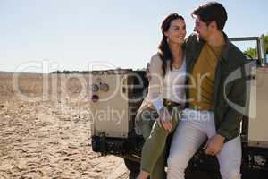 Romantic couple sitting in off road vehicle