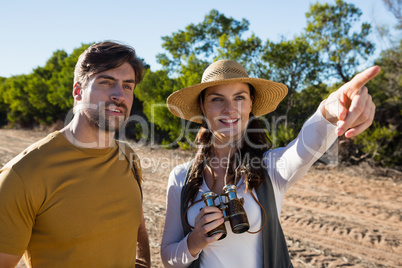 Woman with man pointing on field