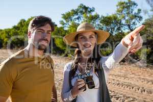 Woman with man pointing on field