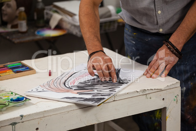 Man sketching in drawing book