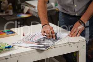 Man sketching in drawing book