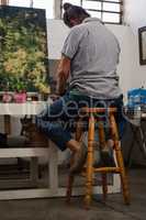 Attentive man painting at table