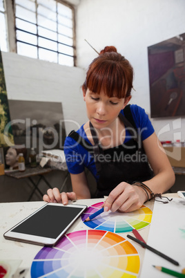 Beautiful woman matching color with color swatch