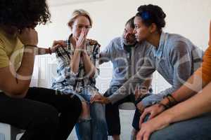 Friends consoling worried woman