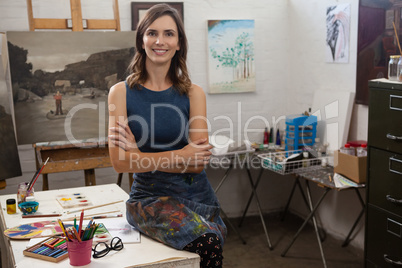 Smiling woman sitting at table in drawing class