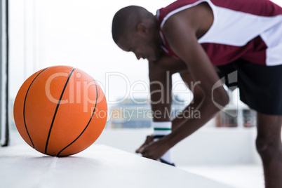 Basketball player tying shoelace