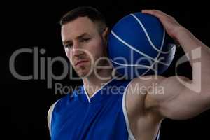 Portrait of confident player holding basketball