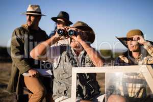 Happy friends enjoying in vehicle during safari vacation