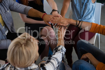 High angle view of friends stacking hands