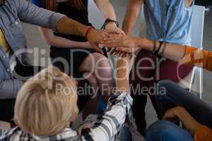 High angle view of friends stacking hands