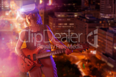 Composite image of young woman playing guitar while wearing virtual reality simulator