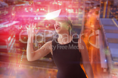 Composite image of cheerful businesswoman looking through virtual reality simulator