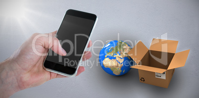Composite image of cropped hand holding phone