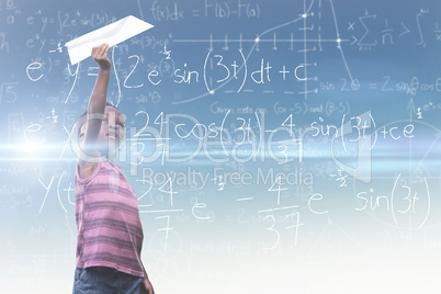 Composite image of boy holding paper airplane