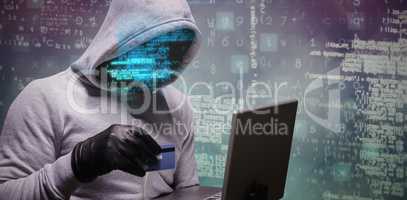 Composite image of hacker using credit card for cyber crime