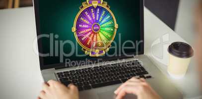 Composite image of graphic image of wheel of fortune on mobile screen