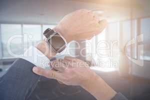 Composite image of cropped hand of businessman wearing smart watch