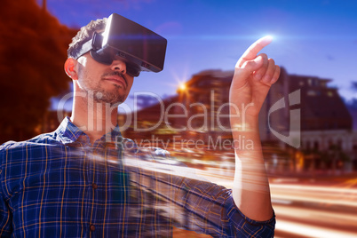 Composite image of businessman looking though virtual reality simulator