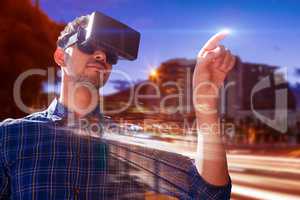 Composite image of businessman looking though virtual reality simulator