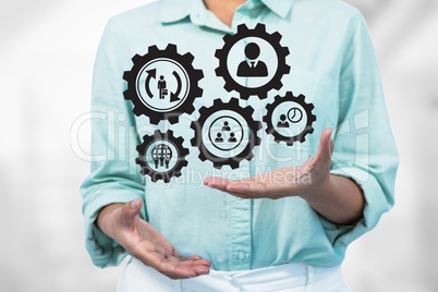 Business woman interacting with people in cogs graphics against white background