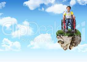Young boy on floating rock platform  in sky in wheelchair