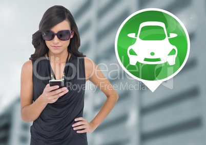 Woman holding phone with car icon in city