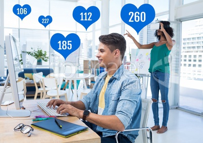 People in office on computer with likes in heart icons