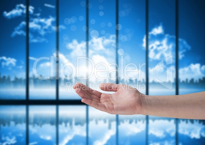 Open hand with blue windows and city background