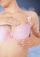 Breast cancer woman with sky clouds background checking in bra
