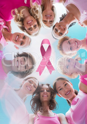 Pink ribbon with breast cancer awareness women putting hands together