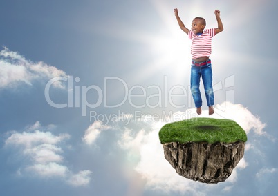 Young boy on floating rock platform  in sky jumping